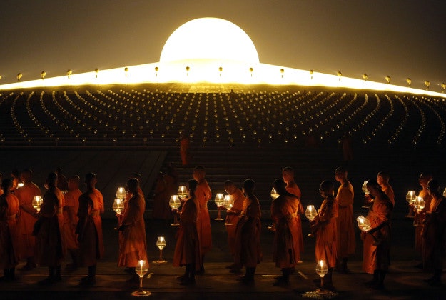 Thai Buddhist monks hold candles as they gather at Wat Dhammakaya temple to participate in Makha Bucha Day ceremonies, in Pathum Thani province, Thailand, Monday, Feb. 22, 2016. Makha Bucha, a religious holiday that marks the anniversary of Lord Buddha's mass sermon to the first 1,250 newly ordained monks 2,559 years ago. 