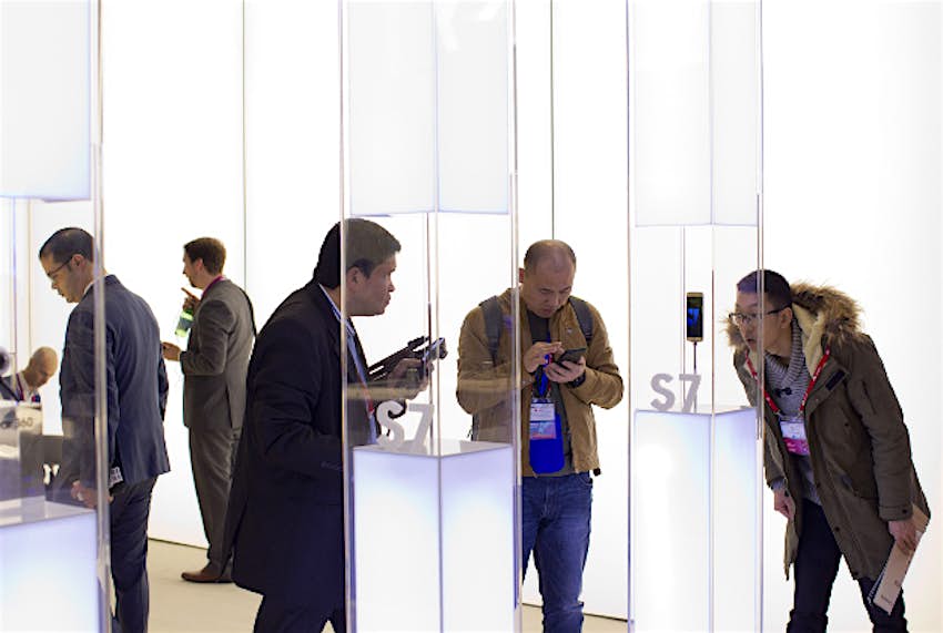 Travel News - 11245771-1 Men look at the new Galaxy S7 phone at the Mobile World Congress wireless show, in Barcelona, Spain, Tuesday, Feb. 23, 2016.