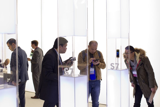 Men look at the new Galaxy S7 phone at the Mobile World Congress wireless show, in Barcelona, Spain, Tuesday, Feb. 23, 2016. 