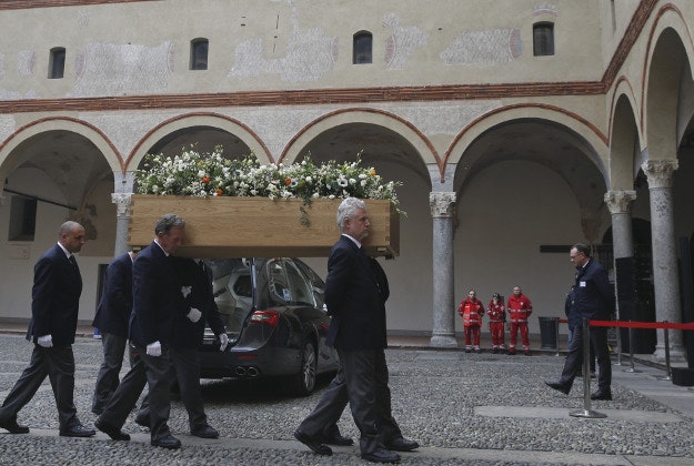 The coffin of Italian writer Umberto Eco is shoulder carried inside the Castello Sforzesco fortress on the occasion of his funeral service in Milan, Italy, Tuesday, Feb. 23, 2016. Eco, best known for the international best-seller, The Name of the Rose, died Friday, Feb. 19, 2016. He was 84. 