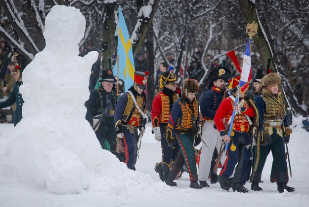 Members of an historic club wearing 1812-era French army uniforms march during an historic festival to mark Defenders of the Fatherland Day in St.Petersburg, Russia, Tuesday, Feb. 23, 2016. The day, honors the nation's military and is a nationwide holiday. 