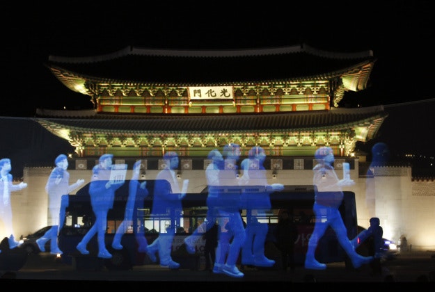 Holograms of protesters are shown on the screen during a holographic demonstration called 'ghost protest', demanding freedom of assembly and guarantee the right to peaceful assembly, in front of the Gwanghwamun, the main gate of the 14th-century Gyeongbok Palace, one of South Korea's well known landmarks, in Seoul, South Korea, Wednesday, Feb. 24, 2016. Protesters appeared on a screen 10 meters long and 3 meters wide in a rally organized by Amnesty International Korea. 