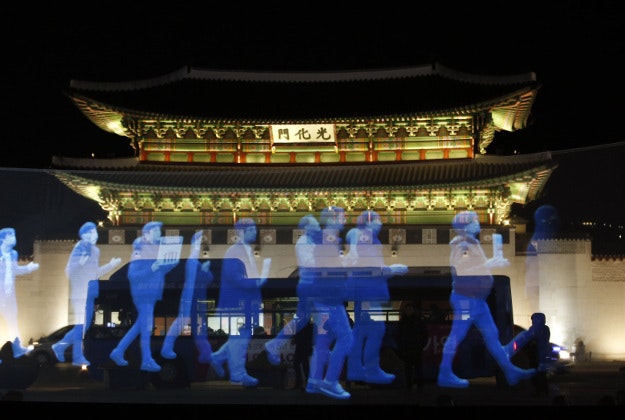 Holograms of protesters are shown on the screen during a holographic demonstration called 'ghost protest', demanding freedom of assembly and guarantee the right to peaceful assembly, in front of the Gwanghwamun, the main gate of the 14th-century Gyeongbok Palace, one of South Korea's well known landmarks, in Seoul, South Korea, Wednesday, Feb. 24, 2016. Protesters appeared on a screen 10 meters long and 3 meters wide in a rally organized by Amnesty International Korea.