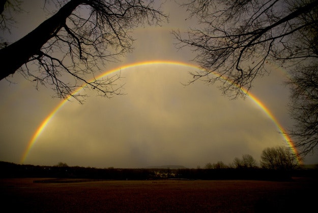 A full rainbow arches over Tom Tudek Memorial Park with Mount Nittany below, in State College, Pa., Wednesday, Feb. 24, 2016. 