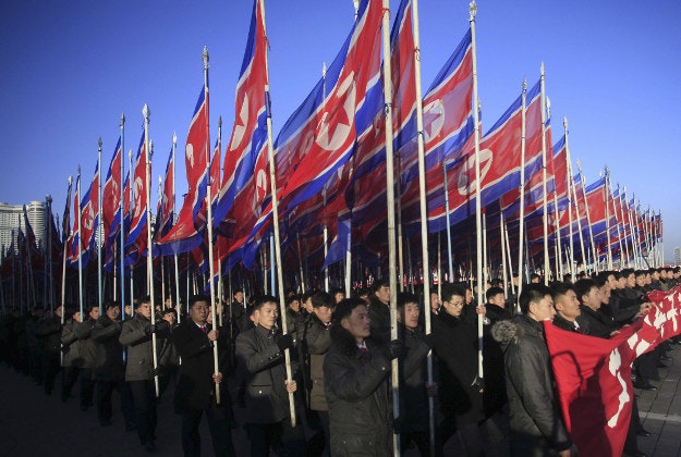 North Koreans parade with the North Korean flag in Kim Il Sung Square in Pyongyang, North Korea, Thursday, Feb. 25, 2016, to show their loyalty to the Workers' Party. North Korea is massing its people to hunker down and work harder with a new "70-day campaign of loyalty" in the run up to a major meeting of its ruling Workers' Party in May.