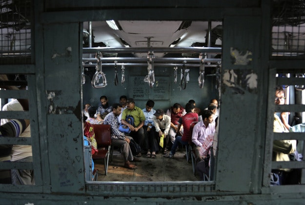Indian commuters board a reserved compartment of a train at the railway station in Allahabad, India, Thursday, Feb. 25, 2016. Indian railway minister Suresh Prabhu Thursday unveiled the budget for one of the world’s largest railways network that serves more than 23 million passengers a day. Once a pride of the Indian government, it’s now hobbled by ageing infrastructure. 