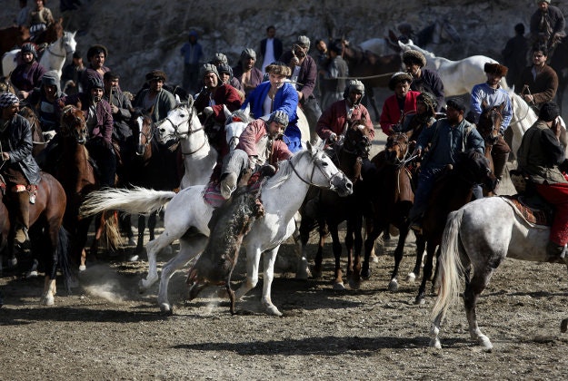 Afghan horse riders compete for the goat during a friendly buzkashi match on the outskirts of Kabul, Afghanistan, Thursday, Feb. 25, 2016. Buzkashi is a traditional and the national sport of Afghanistan, where players compete to place a goat carcass into a goal circle. It was banned during the Taliban rule. 