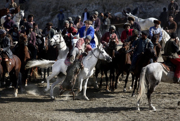 Afghan horse riders compete for the goat during a friendly buzkashi match on the outskirts of Kabul, Afghanistan, Thursday, Feb. 25, 2016. Buzkashi is a traditional and the national sport of Afghanistan, where players compete to place a goat carcass into a goal circle. It was banned during the Taliban rule.
