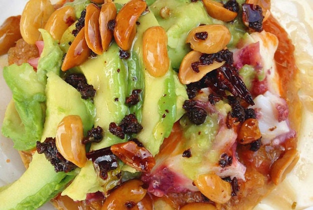cod and octopus ceviche tostada with salsa of dried chiles, peanuts, avocado, and a guacamole blended with chile serrano from #laguerrerense #ensenada | photo by @streetgourmetla | #bourdainmarket