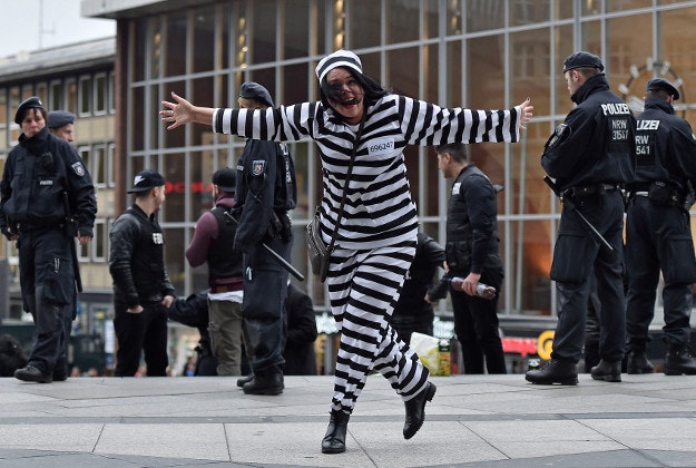 A female reveler celebrates in front of police during the start of the street carnival in Cologne, Germany.