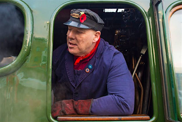 Travel News - flying scotsman london 1 Crew members in the cab of the Flying Scotsman before its inaugural run from Kings Cross station, London, to York after a decade long, £4.2 million refit.