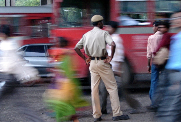 Indian police guide traffic in Mumbai.