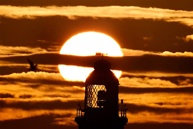 Travel News - pic 5 The sun rises over the house on St Mary's lighthouse today in Whitley Bay