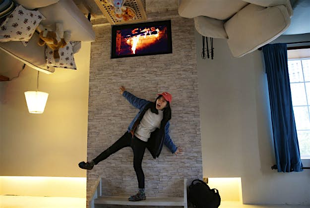 Travel News - upside down house taiwan 1 A visitor poses inside an upside-down house created by a group of Taiwanese architects at the Huashan Creative Park in Taipei, Taiwan.