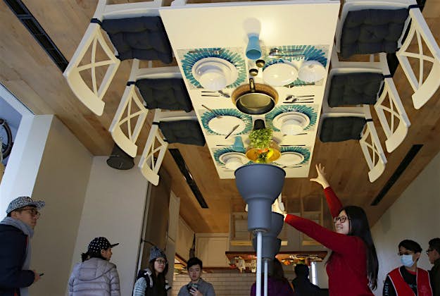 Travel News - upside down house taiwan 2 Visitors look around inside an upside-down house created by a group of Taiwanese architects at the Huashan Creative Park in Taipei, Taiwan.