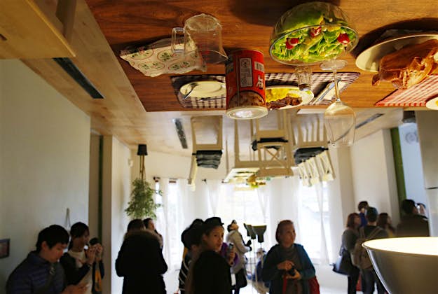 Travel News - upside down house taiwan 3 A visitor poses inside an upside-down house created by a group of Taiwanese architects at the Huashan Creative Park in Taipei, Taiwan.