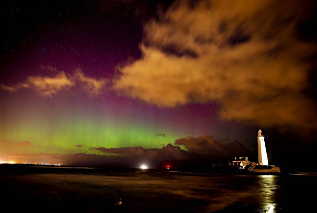 Travel News - 11364691-1 The Northern Lights, or Aurora Borealis, shine over the Sycamore Gap at Hadrian's Wall in Northumberland. The ethereal spectacle is caused by charged solar particles interacting with the Earth's magnetic field and is usually only visible in the far north of Scotland.