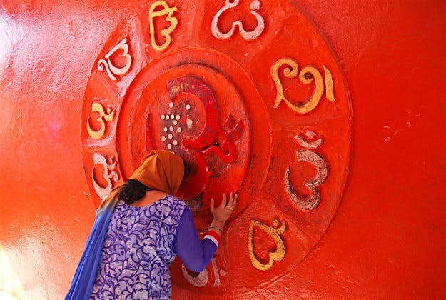 Travel News - 11364851-1 An Indian Hindu woman devotee prays at a temple on the occasion of the Mahashivratri festival in Jammu, India, Monday, March 7, 2016. Hindus across the world are celebrating Mahashivratri, or Shiva's night festival believed to be the day when Shiva got married.