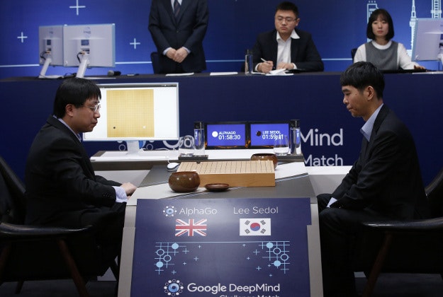 South Korean professional Go player Lee Sedol, right, prepares for his second stone against Google's artificial intelligence program, AlphaGo, as Google DeepMind's lead programmer Aja Huang, left, sits during the Google DeepMind Challenge Match in Seoul, South Korea, Wednesday, March 9, 2016. Google's computer program AlphaGo defeated its human opponent, South Korean Go champion Lee Sedol, on Wednesday in the first game of a historic five-game match between human and computer.