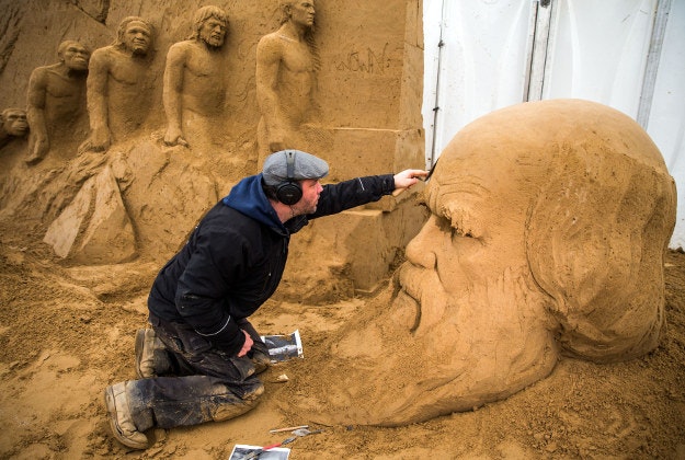 Ferenc Monostori from Hungary is working on the head of Charles Darwin at the sand sculpture show in Binz on Ruegen island, Germany, Wednesday, March 9, 2016. With the motto 'Fascination Nature', 50 sand artists create sand sculptures that lead to the five continents of planet Earth.