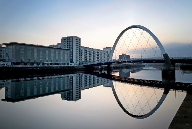 A landmark of Glasgow, the Clyde Arc Bridge, is reflected in the unusually still waters of the River Clyde, Glasgow. 