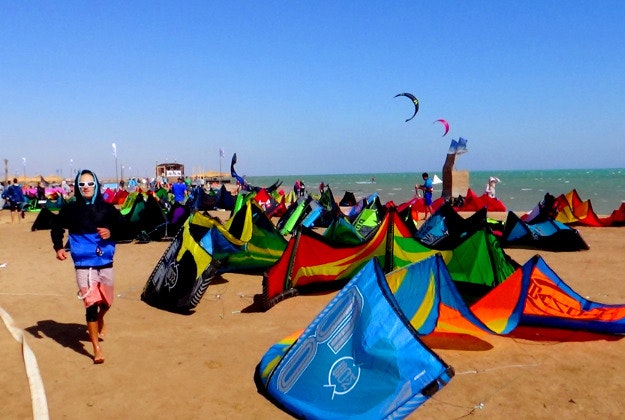A man makes his way before the first stage of the world kite boarding championship begins in Egypt’s Red Sea resort of el-Gouna, Monday, March 21, 2016. Competition for the world kiteboarding championship has kicked off in el-Gouna, with 65 contestants from 26 countries shooting across the water and twirling through the air in hopes of winning 50,000 euros ($56,000) in prizes.