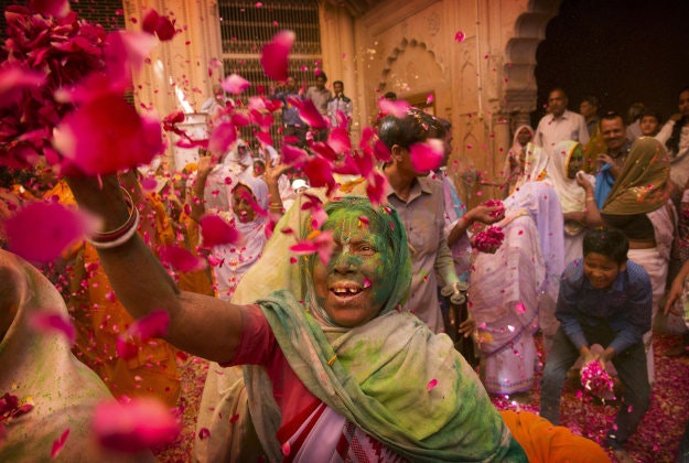 Indian Hindu widows throw flower petals and colored powder during Holi celebrations at the Gopinath temple, 180 kilometres (112 miles) south-east of New Delhi, India Monday, March 21, 2016. A few years ago this joyful celebration was forbidden for Hindu widows. Like hundreds of thousands of observant Hindu women they would have been expected to live out their days in quiet worship, dressed only in white, their very presence being considered inauspicious for all religious festivities.