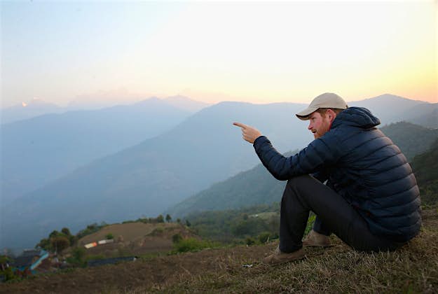 Travel News - 11504531-1 (1) Prince Harry watches the sun rise after spending the night in the Himalayan hilltop village of Leorani on day four of his visit to Nepal on March 22, 2016 in Bardia, Nepal. Prince Harry is on a five day visit to Nepal, his first official tour of the country.