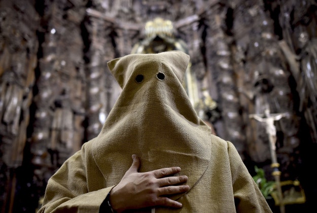 An 'Ensacado,'' or masked penitent, takes part in the procession of the "Silencio del Santisimo Cristo del Rebate" brotherhood, during Holy Week in Tarazona, northern Spain, Tuesday, March 22, 2016. Hundreds of processions take place throughout Spain during the Easter Holy Week. 