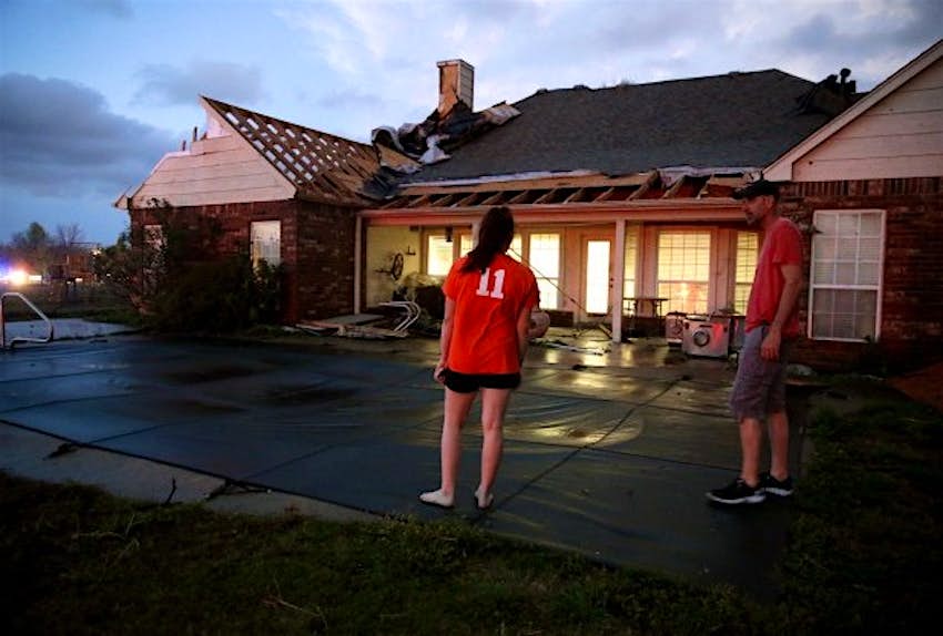 Travel News - US Weather 080520 Sydney Ellis looks at the damage to her family's home near Stone Canyon, Oklahoma