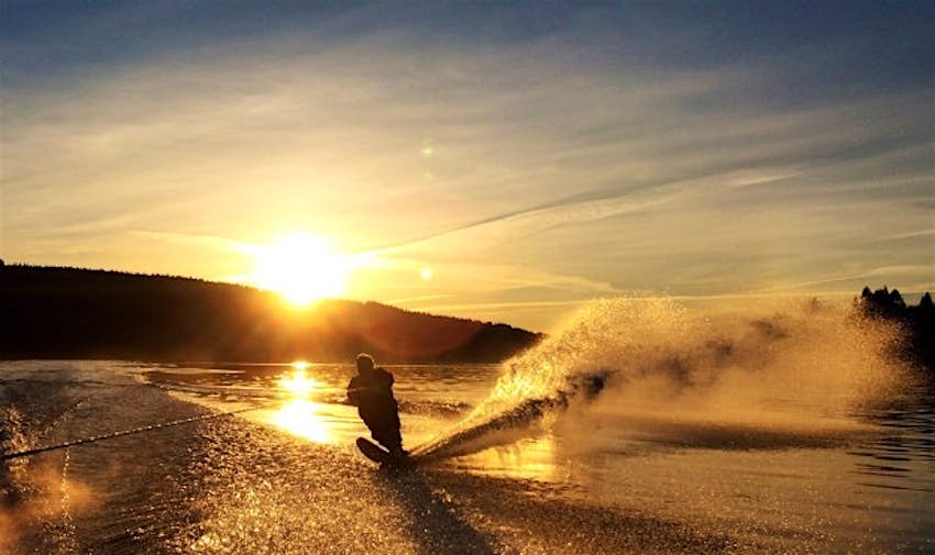Travel News - CANADA Waterski 080543 Barry McKnight is silhouetted by the morning sunlight in Port Moody, Canada