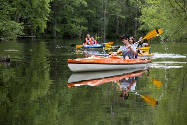 People take kayak trip on Krutynia river in Masurian district of Poland