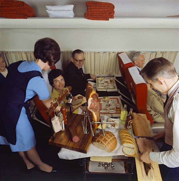 Travel News - SAS DC-8-33 Air hostesses and stewards were trained in how to serve passengers full course meals.