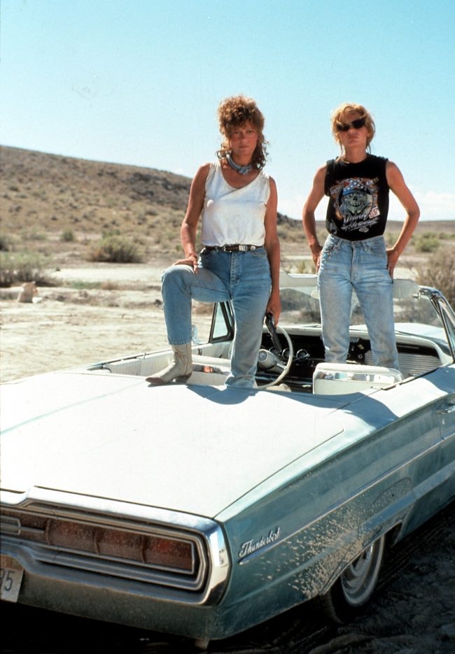 Susan Sarandon and Geena Davis standing in the convertible in publicity portrait for the film 'Thelma & Louise', 1991. (Photo by Metro-Goldwyn-Mayer/Getty Images)