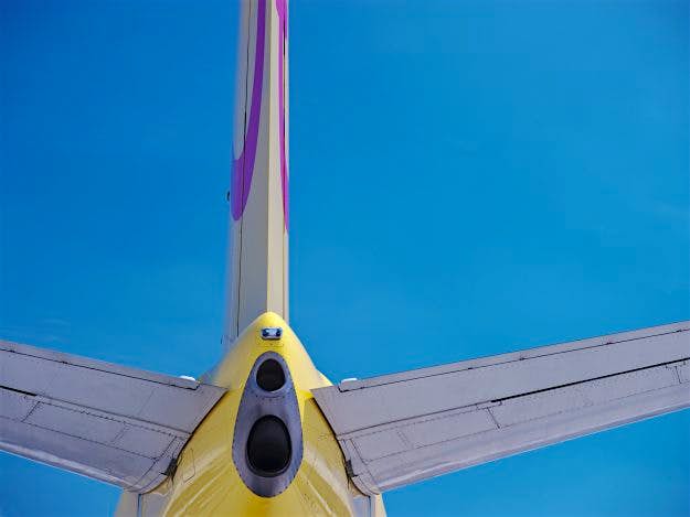 Travel News - Yellow Aircraft against Blue Sky Some 231 million people are expected to travel this summer