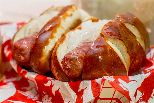 Travel News - 23_beer_brat_buddies Beer Brat Buddies Oktoberfest beer brat in a German pretzel bun with sauerkraut, chopped onions and a choice of mustards – a serving for two!