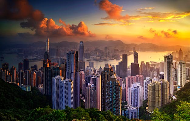 Travel News - Hong Kong Cityscape view at sunrise with Victoria Peak in background, Hong Kong.