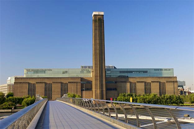 Travel News - Early morning view of the Tate Modern art gallery from the Millenium Bridge in London, housing the national collection of international contemporary and modern artworks, the former Bankside power station on the south bank of the Thames River The Tate Modern art gallery, former Bankside power station