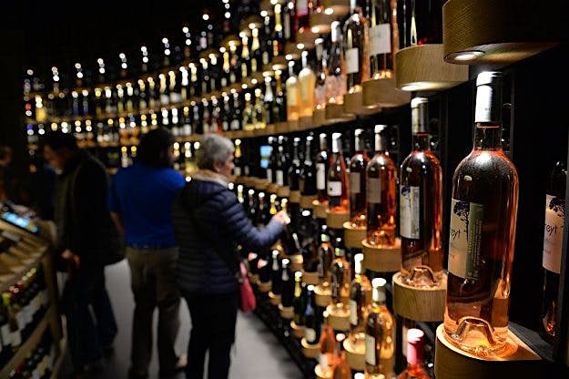 Travel News - WINE-GASTRONOMY-TOURISM-ARCHITECTURE-CULTURE People look at bottles of wine as they visit La Cite du Vin (Wine Museum) as it opens its doors to the public in Bordeaux on June 1, 2016. La Cite du Vin opened its doors to the public on June 1. The 13 350 m2 compound offers thematics areas about the history and civilisations of wine around the world with digital and sensory exhibits. / AFP / MEHDI FEDOUACH (Photo credit should read MEHDI FEDOUACH/AFP/Getty Images)