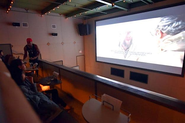 Travel News - NYC Movie Serving staff move about the theatre during the movie