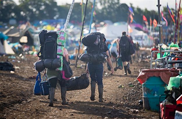 Travel News - Clear-Up Begins After The Glastonbury Festival Departing festival goers pass rubbish left behind at the Glastonbury Festival