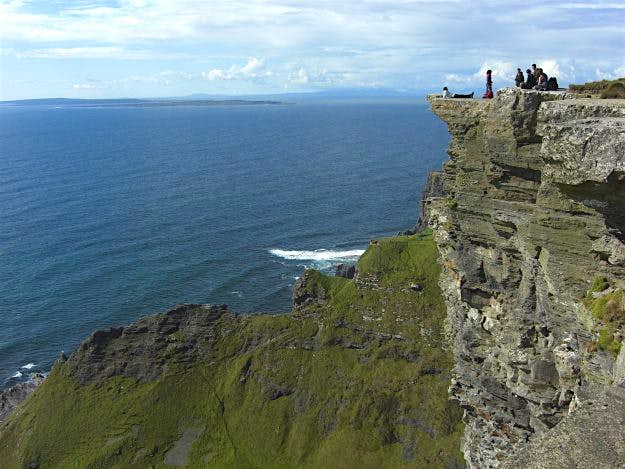 Travel News - Visitors at Cliffs of Moher Visitors are asked to use caution and to avoid getting too close to the cliff edge.