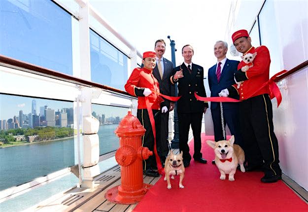 Travel News - cunard 2 Richard Meadows, center left, President, Cunard, North America, Captain Christopher Wells, center, and David Noyes, center right, CEO, Cunard, joined by Cunard Kennel Masters, cut a ribbon to unveil the remastered kennels on the Queen Mary 2 (Diane Bondareff/AP Images for Cunard