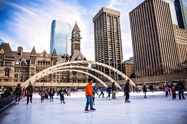 Children ice skating at Nathan Phillips Square in Toronto, Canada. 