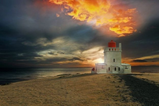 Iceland lighthouses often have dramatic architecture like this castle-like building.