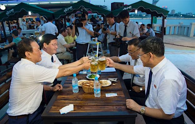 Travel News - NKOREA-FOOD-DRINK-BEER-FESTIVAL Choe Yong Nam, director of the General Bureau of Public Service who doubles as chairman of the preparatory committee for the festival, saying "cheers" with other officials after the opening ceremony of the Pyongyang Taedonggang Beer Festival.