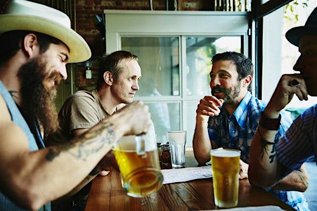 Travel News - Group of friends sharing drinks in restaurant This could be you and your friends if plans for a beer-friendly hotel get off the ground.
