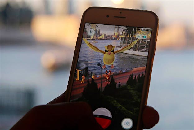 Travel News - Pokemon GO PA A fan manoeuvre his smartphone as he plays Pokemon Go in Hong Kong. (AP Photo/Kin Cheung)