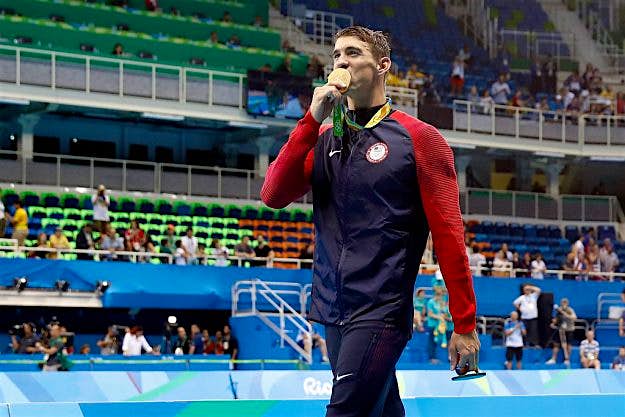 Travel News - michael phelps Michael Phelps takes gold at the Aquatic Stadium which was not filled to capacity.