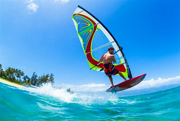 Travel News - Windsurfing, skimming over wave. The app includes useful tips for water safety as Hawaii is a popular destination for water based activities.